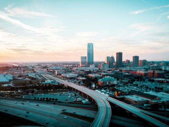 Aerial image of sunset on Oklahoma City with highways approaching and leaving the city.