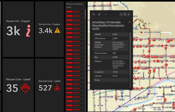 A computer dashboard shows a pale yellow map with red stars pinpointing service lines.