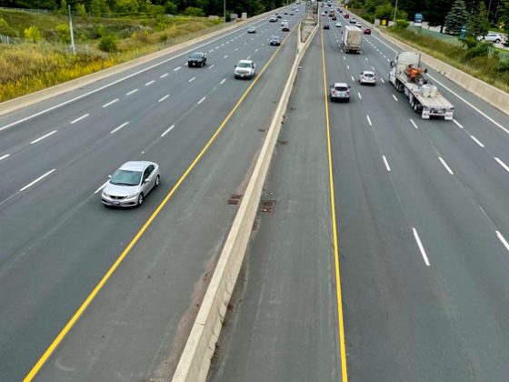 Looking down at an eight-lane highway from a bridge overpass.