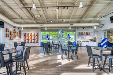 The Penn State University Athletic Administration Building's trophy room is filled with multiple trophy displays, including shelves of awards and a "We Are Penn State" sign.