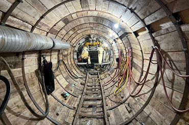 The inside of a waterline tunnel lined with wooden boards.