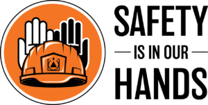 Orange circle containing white and black hands behind a hard hat with the Gannett Fleming icon and the words Safety is in Our Hands.